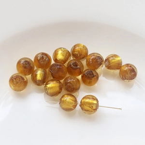 Macro view of gold foil translucent crystal beads for DIY jewelry and handmade bracelets