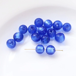 Detail view of cobalt blue foil-lined glass round beads for DIY jewelry making crafts