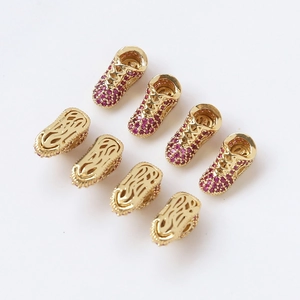 Gold-plated sneaker charms with red cubic zirconia and hollow sole design
