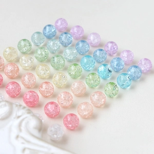 Macro shot of macaron colored crackle glass beads in a neat diagonal pattern for jewelry DIY