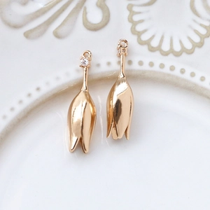 Detail of tulip flower charms in gold plated brass with cubic zirconia for jewelry making