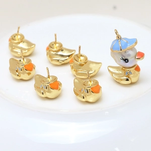 Gold-plated duck jewelry set with cartoon studs and baroque pearl pendant on a white plate