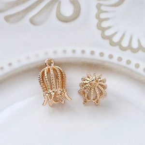 Macro detail of gold-plated filigree flower cap pendants for DIY jewelry making