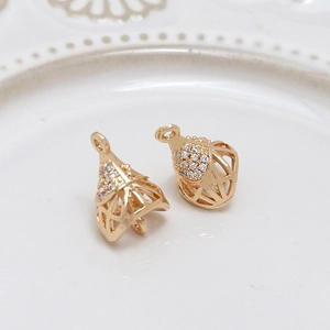 Macro shot of 18K gold-plated hollow lantern pendants with sparkling cubic zirconia