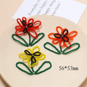 Handmade beaded flower charms in red, orange, and yellow with size details of 56x53mm