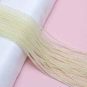 Détail de perles de rocaille 2mm crème irisées au fini nacré pour la création de bijoux DIY