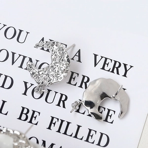 Macro shot of 925 sterling silver moon stud earrings with irregular hammered texture