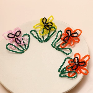 Handmade beaded flower charms in pink and yellow for DIY jewelry and earring making