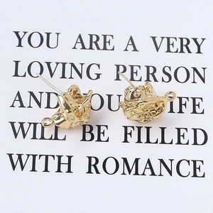 Detailed macro view of 925 silver crescent moon earrings with irregular gold texture