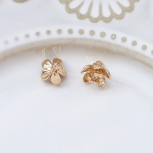 Detailed view of gold-plated flower spacers with intricate zircon accents for DIY jewelry