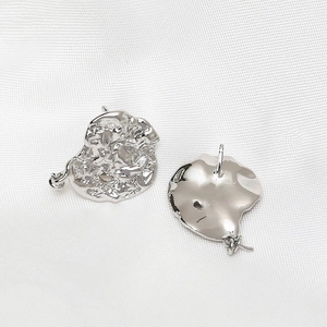 Detail of silver 925 moon earrings with irregular lava texture and DIY hanging loop