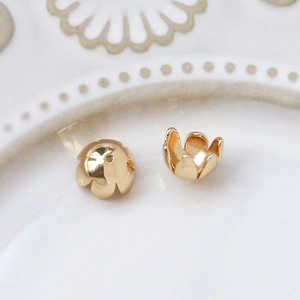 Detail of 18K gold-plated hollow flower bead caps for DIY jewelry necklace making