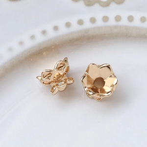Macro shot of gold-plated five-petal flower bead caps for DIY jewelry making