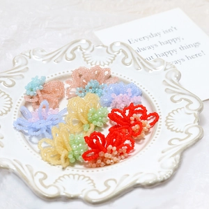 Macro shot of colorful beaded flower accessories for DIY earrings and hair jewelry