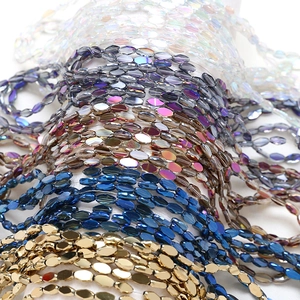 Close-up of faceted crystal glass beads in various iridescent colors for DIY jewelry making