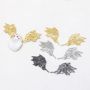 Close-up of gold dragon wing charms with detailed texture for DIY jewelry making