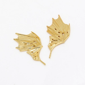 Detailed macro view of 14K gold plated dragon wing DIY charms with hollow dot texture