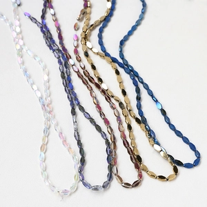 Macro view of multi-faceted crystal glass beads in aurora white and purple for DIY jewelry