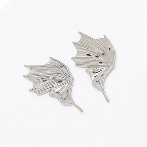 Detailed view of silver dragon wing ear accessories with realistic bone texture and pins