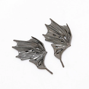 Macro detail of gunmetal bat wings metal charms for DIY jewelry making with bony texture
