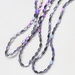 Macro detail of faceted oval glass beads with iridescent purple AB coating for DIY jewelry