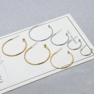 Detail view of gold and silver C-shaped earring hooks in four sizes on display card