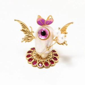 Detailed view of Baroque pearl brooch with golden wings and zircon flower base