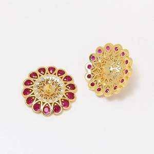 Gold-plated floral stud earrings with ruby-colored zircon petals and white crystal core