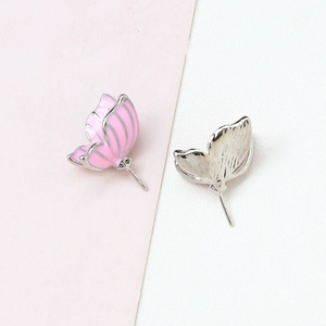 Detail of pink enamel butterfly jewelry components with gold plated silver metal base