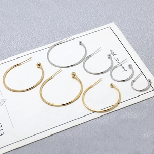 Minimalist gold and silver C-shaped hoop earrings with small beads in various sizes