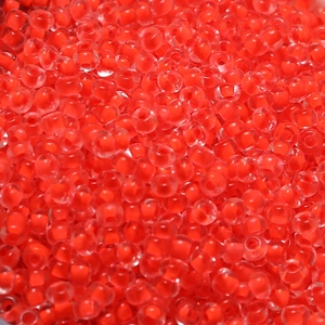 Macro shot of 4mm red transparent glass seed beads for DIY jewelry making accessories