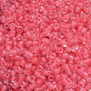Macro detail of 4mm pink seed beads with dyed core for DIY jewelry and crafts