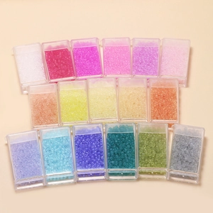 Macro detail of 17-color 3mm frosted seed beads in clear boxes for DIY jewelry making