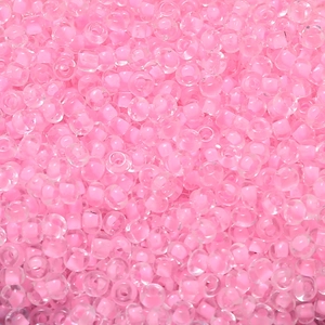 Macro shot of 4mm macaron pink seed beads with cream cores for DIY jewelry making