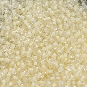 Macro shot of 4mm cream core glass seed beads for DIY jewelry making and craft projects