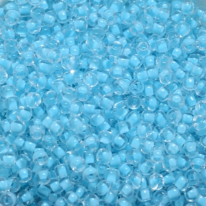 Macro view of 4mm light blue transparent glass seed beads with dyed core for DIY jewelry