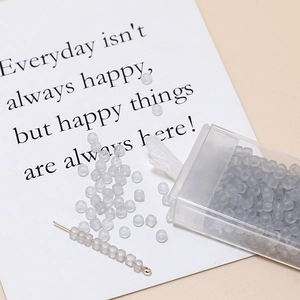 Detailed view of 3mm frosted grey DIY beads with storage box and threading needle