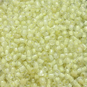 Macro shot of 4mm light yellow translucent glass seed beads for DIY jewelry making crafts