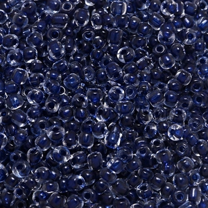 Detailed macro view of 4mm dark blue translucent glass seed beads for DIY jewelry making