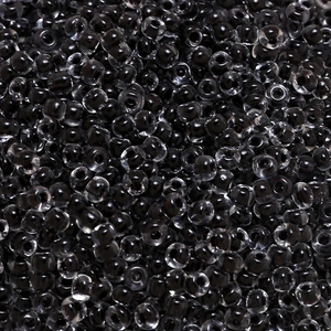 Macro shot of 4mm transparent black glass seed beads for DIY jewelry and crafts