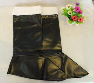 Detail of shiny black PU leather Santa boot covers with white faux fur trim on top