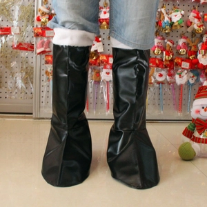Detail of black faux leather Santa boots with plush white fur trim for festive costumes