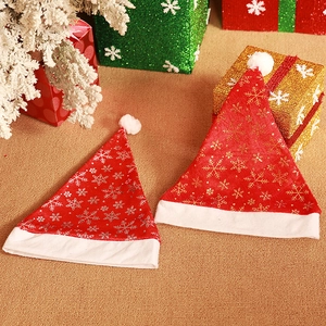 Détails macro des bonnets de Noël en velours rouge avec flocons d'argent et pompons blancs