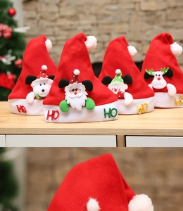 Close-up of fluffy white pom-pom detail on red Christmas hat with festive patterns