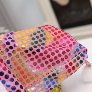 Detail of pink Christmas hat fabric with shiny rainbow metallic polka dots and texture