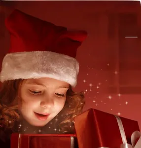 Detailed view of plush red Christmas hat with white pompom next to gift boxes