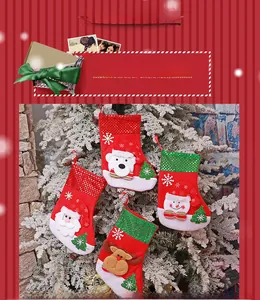 Detail of Christmas stockings with sequins featuring Santa, snowman, and reindeer figures
