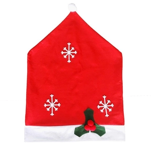 Christmas Santa hat chair covers with white snowflake patterns and holly leaf accents