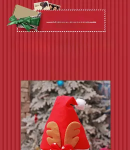 Detail of red Christmas hat with reindeer antlers, white pom-pom and polka dot bow