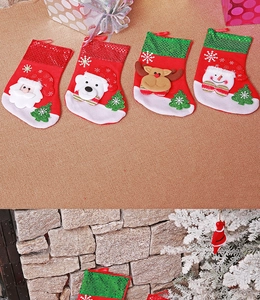 Detail of Christmas stockings with Santa, reindeer, and sequin trim for holiday gifts